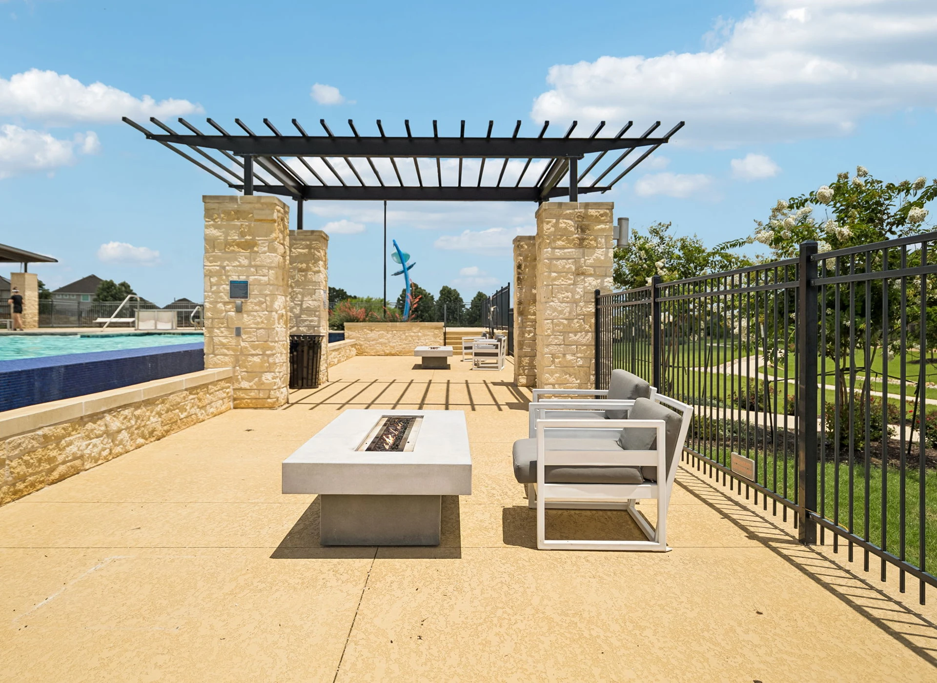 Outdoor patio with seating and fire pit.