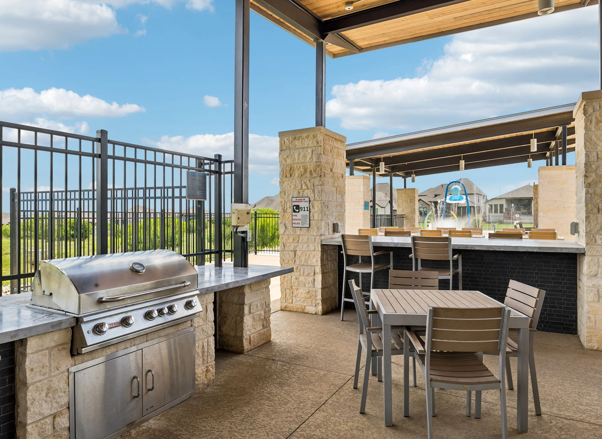 Outdoor patio with grill and dining area.