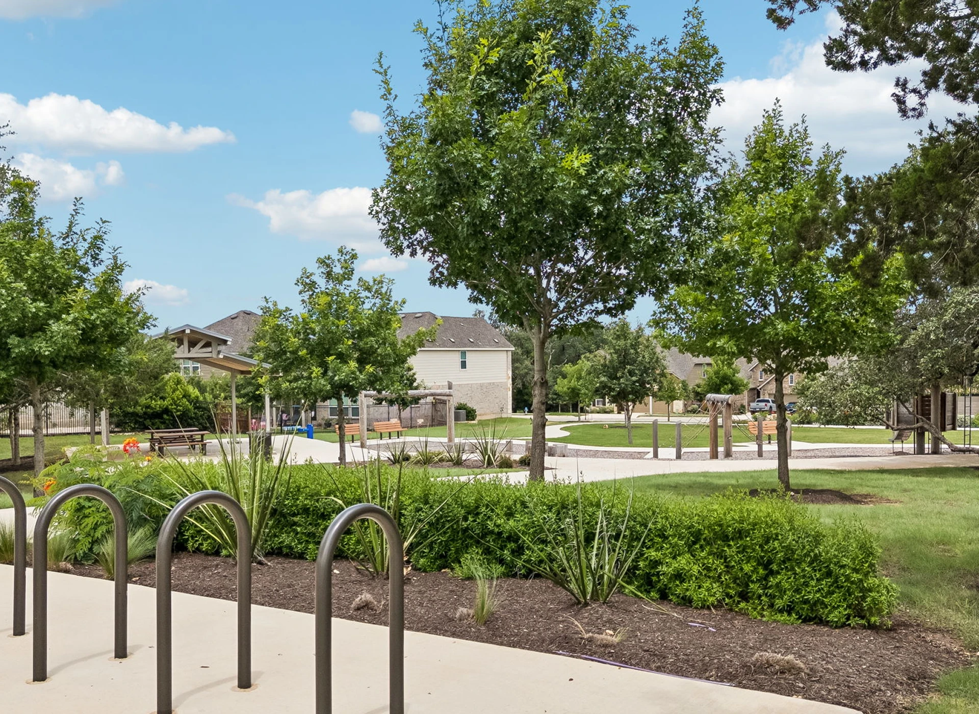Suburban park with trees and pathways.