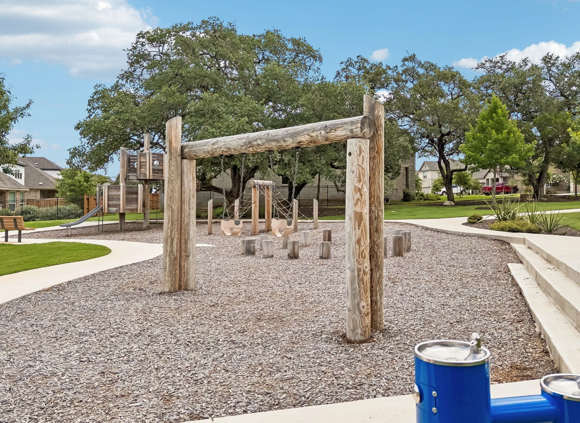Playground with wooden structures and trees.