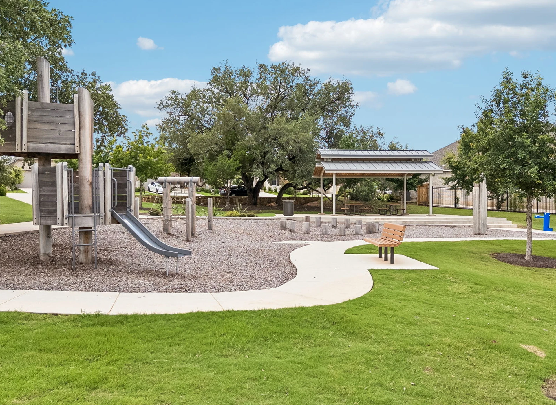 Playground with slide and green grass area.