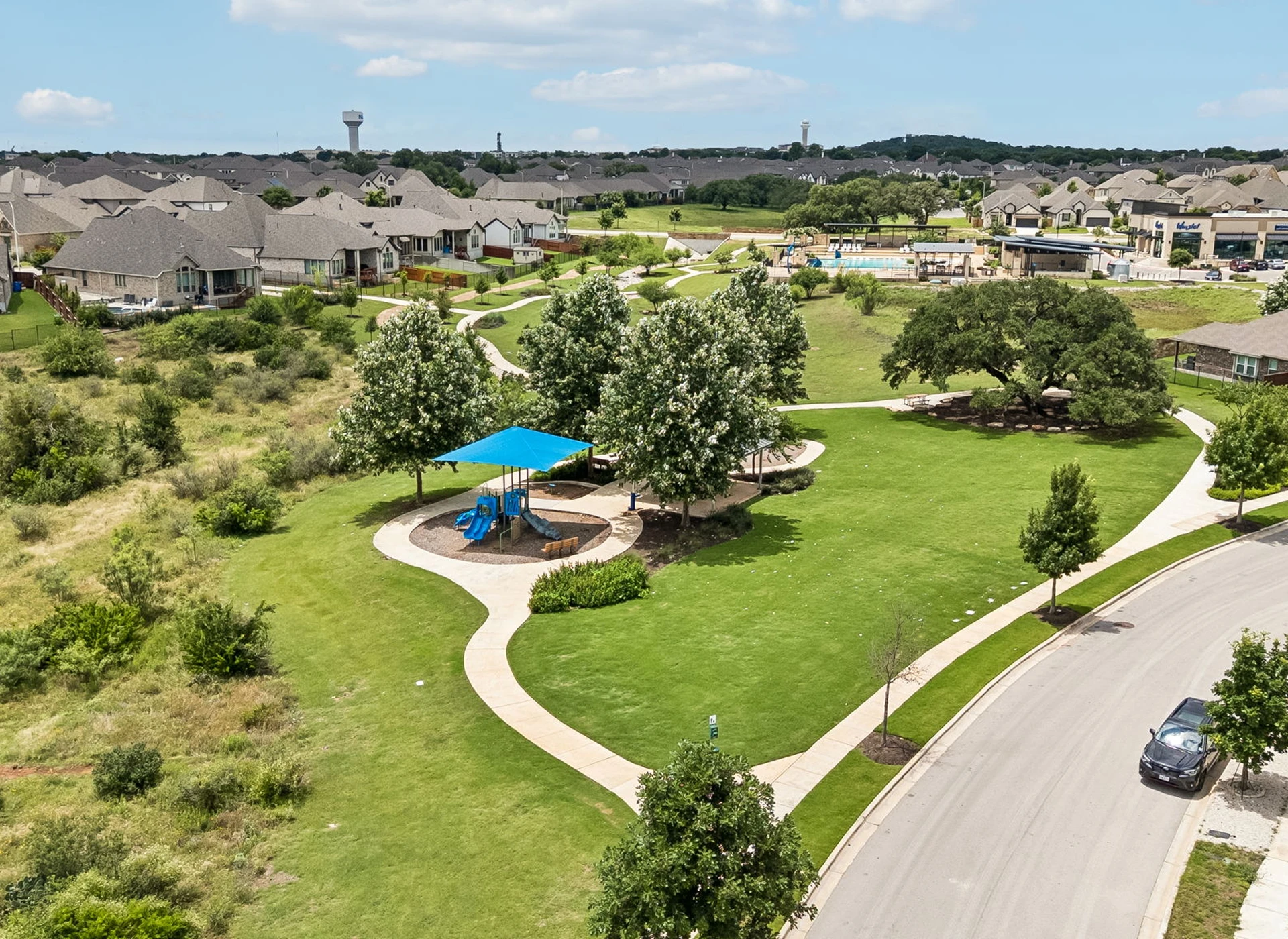 Suburban park with playground and walking paths.