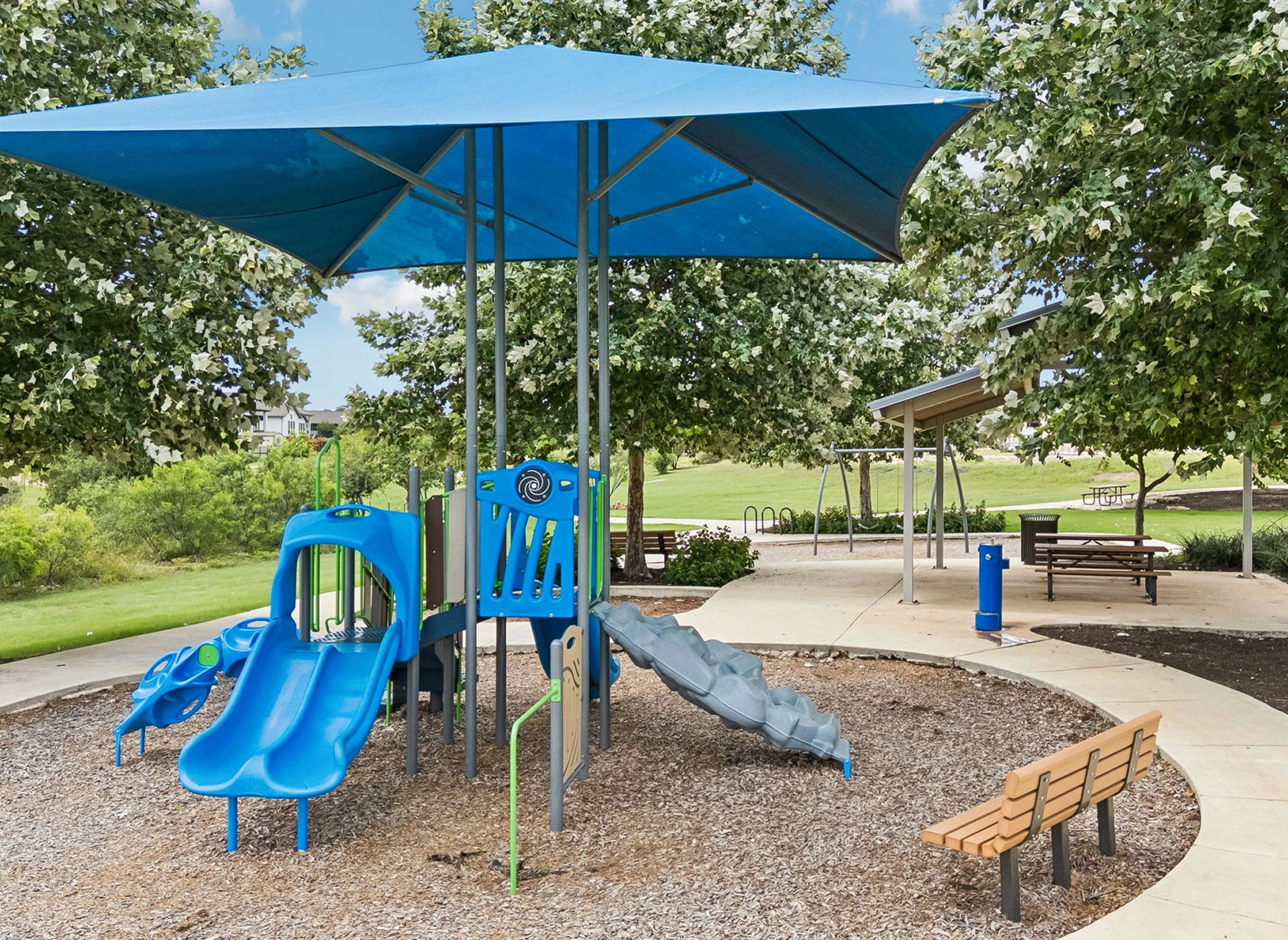 Playground with blue slides and canopy.